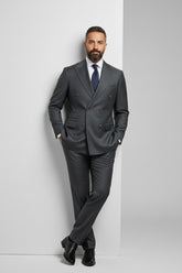 Man wearing charcoal pinstripe double-breasted suit with tailored fit and tie.